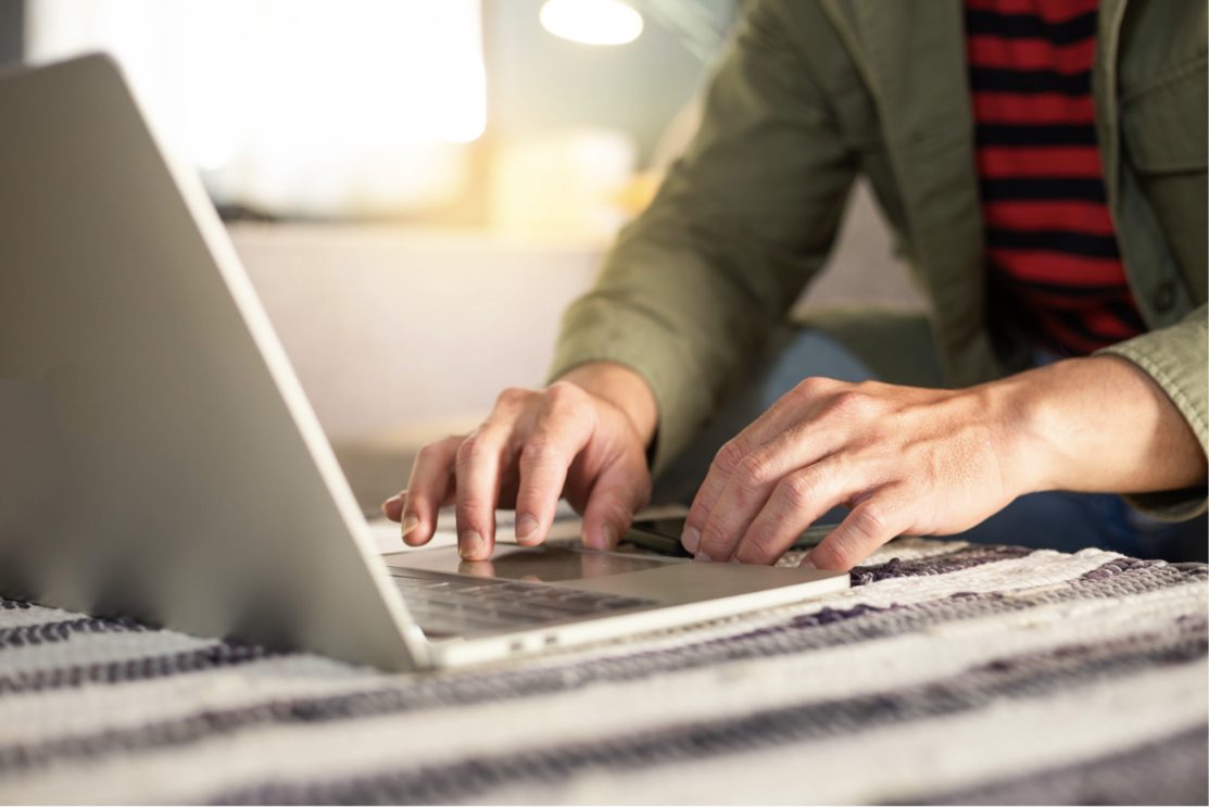 A young person working on a laptop