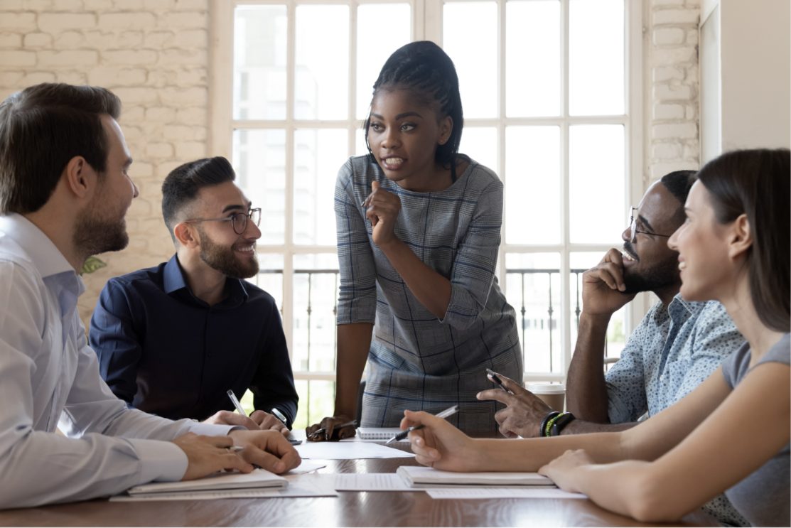 A manager leading a discussion with her team around a table